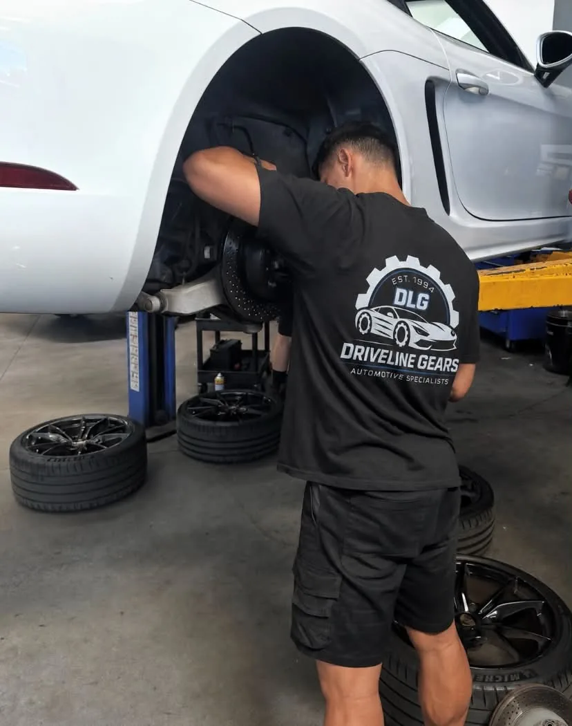 Driveline Gears mechanic replacing the front brakes on a sports car in the Wollongong workshop